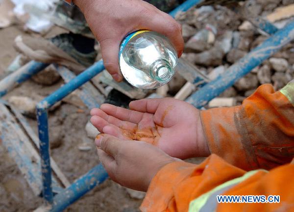 Rescuers work at a residence building in the mudslides-hit Zhouqu County, Gannan Tibetan Autonomous Prefecture in northwest China's Gansu Province, Aug. 10, 2010.