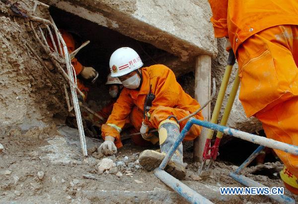 Firefighters search the building relics for victims in the mudslide-hit Zhouqu County, Gannan Tibetan Autonomous Prefecture in northwest China's Gansu Province, Aug. 10, 2010. 