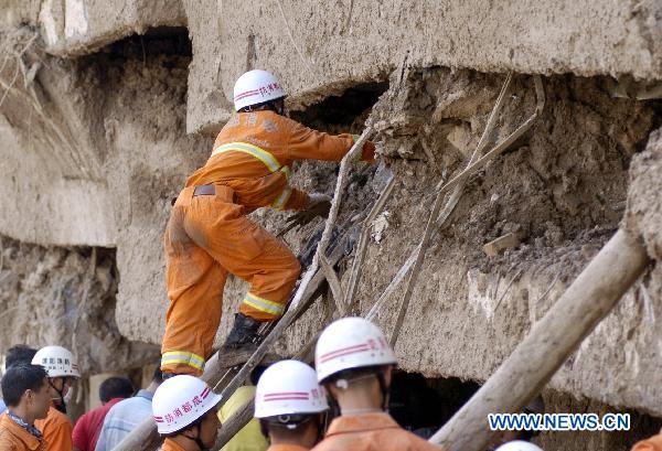 Firefighters search the building relics for victims in the mudslide-hit Zhouqu County, Gannan Tibetan Autonomous Prefecture in northwest China's Gansu Province, Aug. 10, 2010.