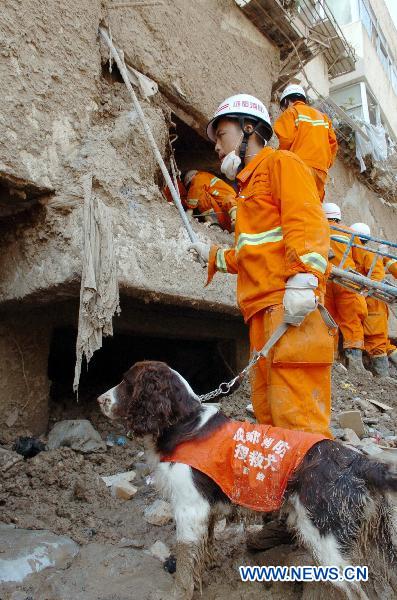 Firefighters search the building relics for victims in the mudslide-hit Zhouqu County, Gannan Tibetan Autonomous Prefecture in northwest China's Gansu Province, Aug. 10, 2010. 