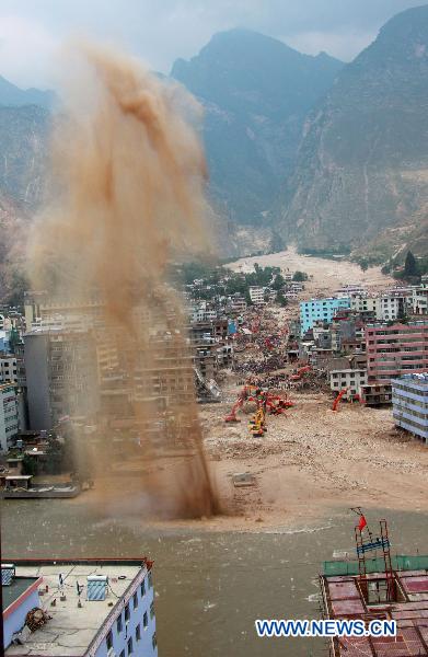 Rescuers conduct the ninth explosion to blast debris damming a river in order to safely release potential flood waters in the mudslides-hit Zhouqu County, Gannan Tibetan Autonomous Prefecture in northwest China's Gansu Province, Aug.10, 2010. 