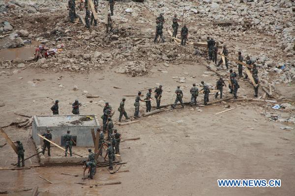 Rescuers prepare for the ninth explosion to blast debris damming a river in order to safely release potential flood waters in the mudslides-hit Zhouqu County, Gannan Tibetan Autonomous Prefecture in northwest China's Gansu Province, Aug.10, 2010. 