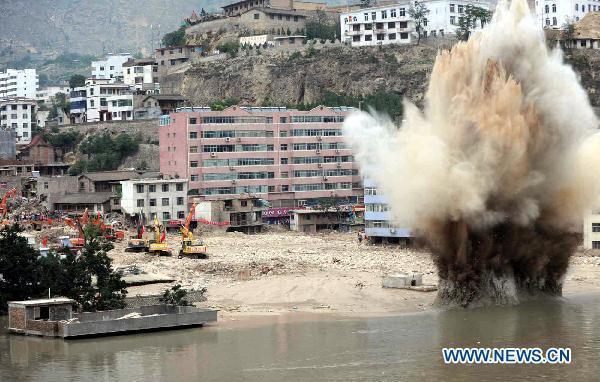 Rescuers conduct the ninth explosion to blast debris damming a river in order to safely release potential flood waters in the mudslides-hit Zhouqu County, Gannan Tibetan Autonomous Prefecture in northwest China's Gansu Province, Aug.10, 2010.