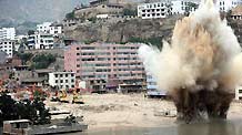 Rescuers conduct the ninth explosion to blast debris damming a river in order to safely release potential flood waters in the mudslides-hit Zhouqu County, Gannan Tibetan Autonomous Prefecture in northwest China's Gansu Province, Aug.10, 2010.