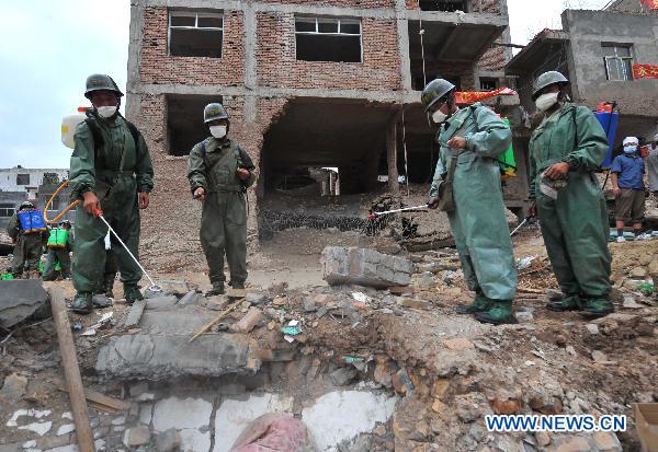 Soldiers sterilize the landslide-hit area in Zhouqu County, northwest China's Gansu Province, Aug. 10, 2010. 
