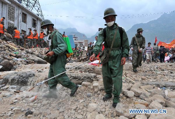 Soldiers sterilize the landslide-hit area in Zhouqu County, northwest China's Gansu Province, Aug. 10, 2010. 