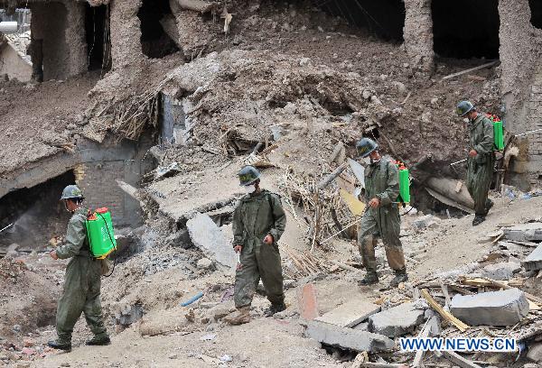 Soldiers sterilize the landslide-hit area in Zhouqu County, northwest China's Gansu Province, Aug. 10, 2010.