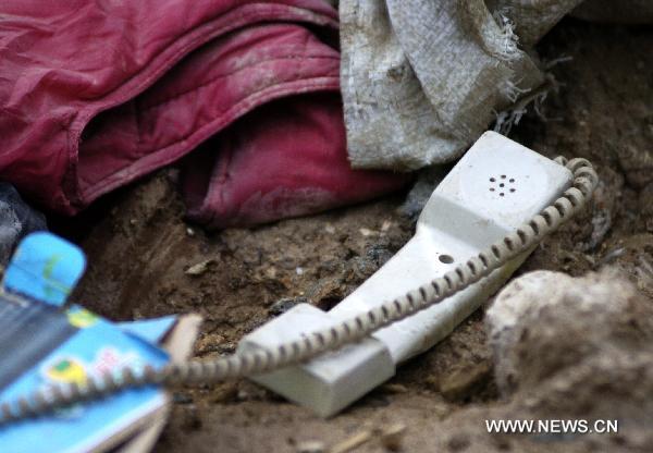 A broken telephone is seen lying in the debris in the photo shot on Aug. 9, 2010. 