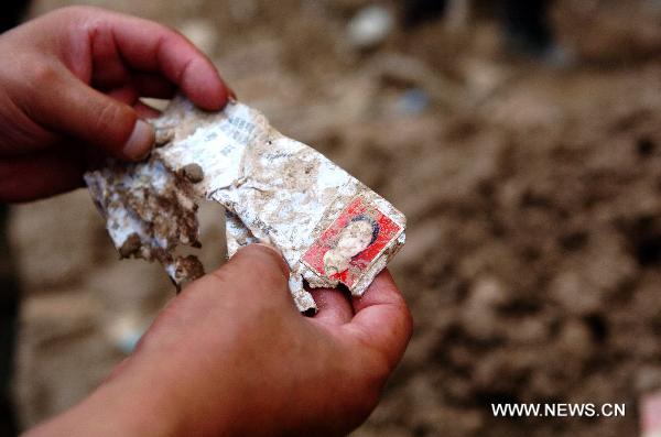 The photo taken on Aug. 9, 2010, shows a scraped exam-sitting permit. With the progress of rescue work, everyday life articles gradually emerged from debris of the massive rain-triggered mudslide in Zhouqu County in northwest China's Gansu Province, recalling people's memories of peaceful life before the disaster.