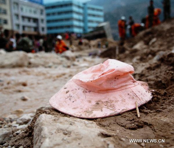 The photo taken on Aug. 9, 2010, shows a mudded pink hat in the debris.