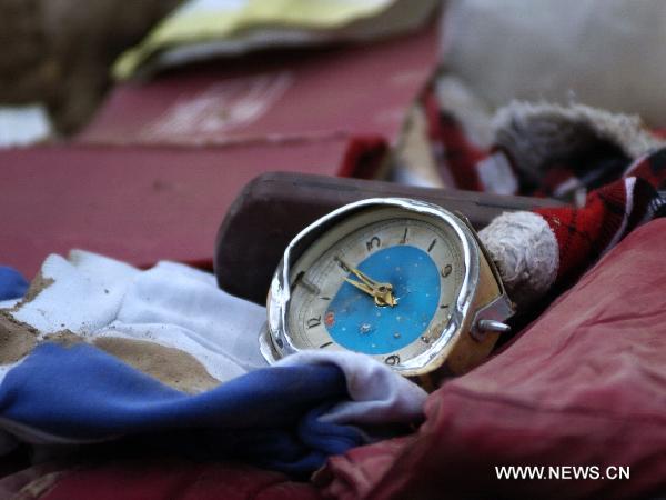 The photo taken on Aug. 9, 2010, shows a broken clock in the debris. 