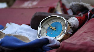 The photo taken on Aug. 9, 2010, shows a broken clock in the debris.