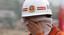 A rescuer sweats off his face in Zhouqu County, Gannan Tibetan Autonomous Prefecture in northwest China's Gansu Province, Aug. 11, 2010.