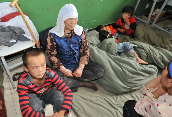 Flood-affected residents take a rest in a temporary shelter in a school in Tongxin County of Wuzhong City in Ningxia Hui Autonomous Region August 11, 2010. 