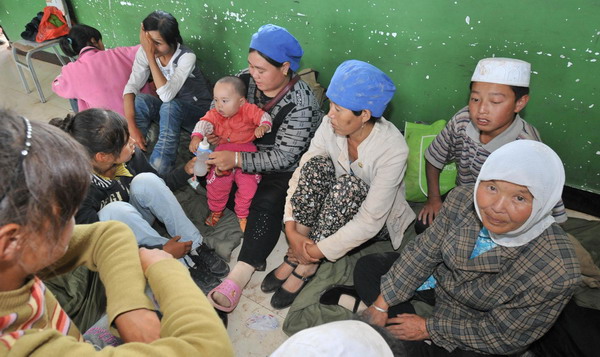 Flood-affected residents take a rest in a temporary shelter in a school in Tongxin County of Wuzhong City in Ningxia Hui Autonomous Region August 11, 2010. 