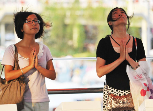 Tourists make wishes inside the Taiwan pavilion at the Shanghai Expo Site, August 10, 2010.