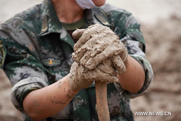 The hands of a young soldier born after 1990 are seen in Zhouqu County, Gannan Tibetan Autonomous Prefecture in northwest China's Gansu Province, Aug. 12, 2010. 