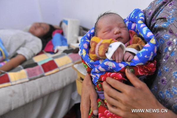 A new-born baby is seen at a hospital in landslide-hit Zhouqu County, Gannan Tibetan Autonomous Prefecture in northwest China's Gansu Province, Aug. 12, 2010.