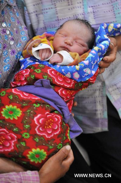 A new-born baby is seen at a hospital in landslide-hit Zhouqu County, Gannan Tibetan Autonomous Prefecture in northwest China's Gansu Province, Aug. 12, 2010.