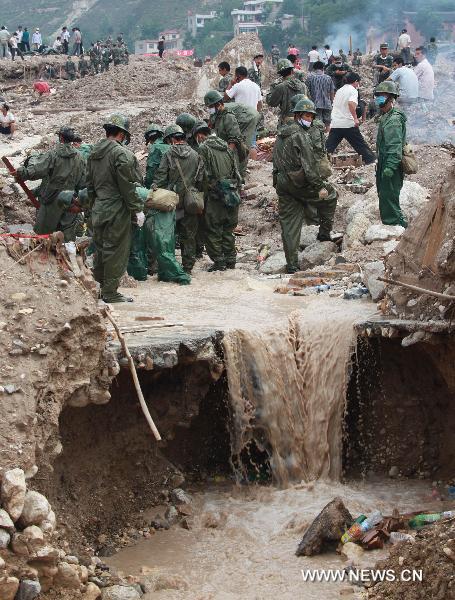 Army soldiers and officers dredge the river channel in landslide-hit Zhouqu County, Gannan Tibetan Autonomous Prefecture in northwest China's Gansu Province, Aug. 12, 2010. 