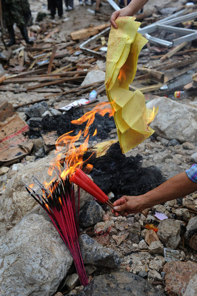 A resident mourns relatives killed by landslide in Zhouqu county, Gannan Tibetan autonomous prefecture in northwest China's Gansu province, Aug. 12, 2010.