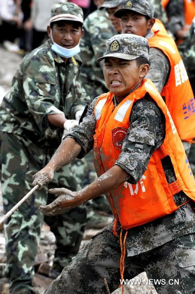 Rescuers work at landslide-hit Zhouqu County, Gannan Tibetan Autonomous Prefecture in northwest China's Gansu Province, Aug. 12, 2010.