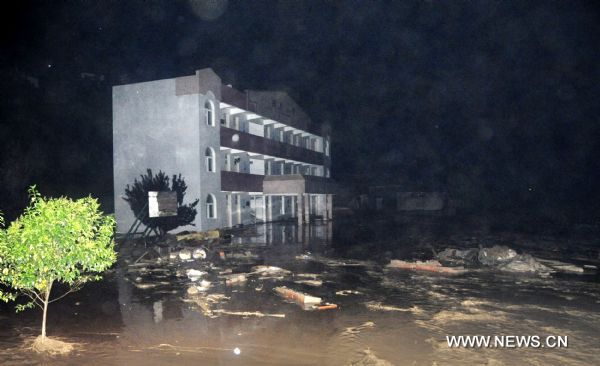 The photo taken late Aug. 12, 2010 shows a school submerged by flood at Jiuguan Village of Wenxian County, northwest China's Gansu Province. Five villages of Wenxian County encountered with landslides triggered by continuous heavy rains, with no casaulties but nine residential houses, two roads and parts of power networks damaged. (Xinhua/Liu Eryin) 