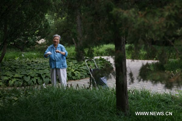 An elderly woman does morning exercises at a park in Beijing, capital of China, Aug. 12, 2010. China has 169 million citizens aged over 60, accounting for 12.5 percent of its total population. The figure would climb up to 31 percent by 2050, said Li Baoku, president of China Aging Development Foundation (CADF), on Wednesday. 