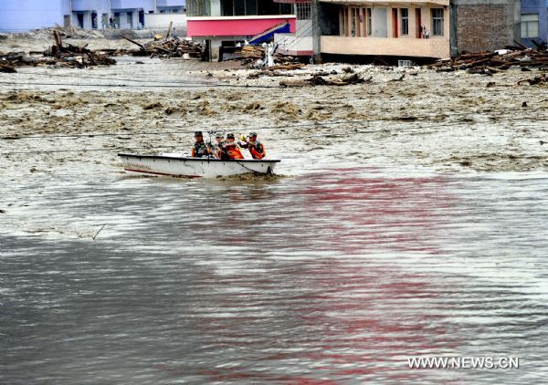 Soldiers settle explosives to dredge water channel in landslide-hit Zhouqu County, Gannan Tibetan Autonomous Prefecture in northwest China's Gansu Province. 