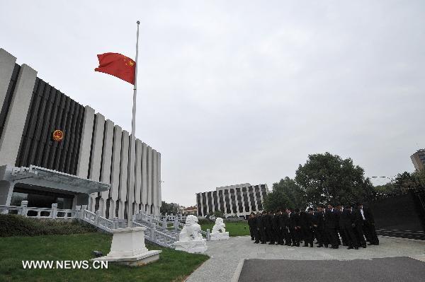 The Chinese flag flies at half mast as staff members of the Chinese Mission to the European Union (EU) pay a silent tribute to the victims of the Aug. 8 mudslide disaster in Zhouqu County, Gannan Tibetan Autonomous Prefecture in northwest China's Gansu Province, in Brussels, capital of Belgium, Aug. 15, 2010. 