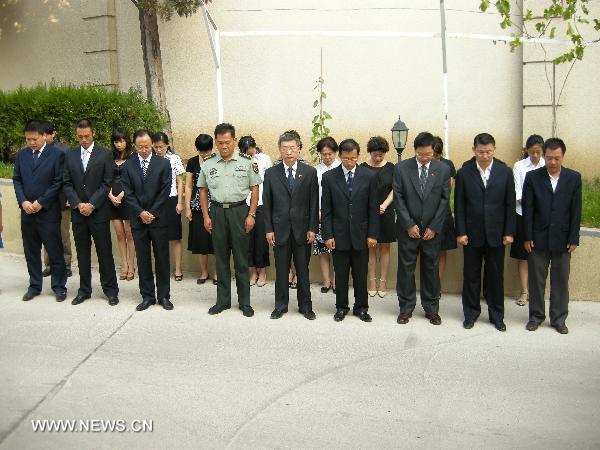 Staff members of the Chinese Embassy pay a silent tribute to the victims of the Aug. 8 mudslide disaster in Zhouqu County, Gannan Tibetan Autonomous Prefecture in northwest China's Gansu Province, in Tbilisi, capital of Georgia, Aug. 15, 2010. 