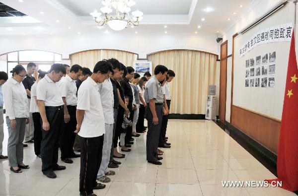 Staff members of the Chinese Embassy pay a silent tribute to the victims of the Aug. 8 mudslide disaster in Zhouqu County, Gannan Tibetan Autonomous Prefecture in northwest China's Gansu Province, in Dar es Salaam, capital of Tanzania, Aug. 15, 2010. 