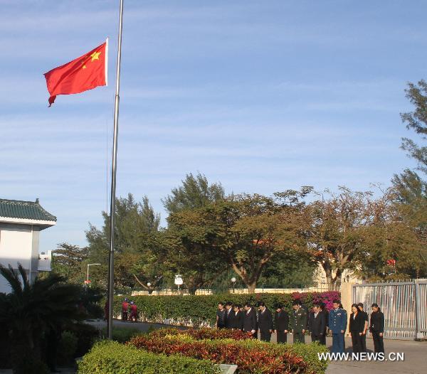 The Chinese flag flies at half mast as staff members of the Chinese Embassy pay a silent tribute to the victims of the Aug. 8 mudslide disaster in Zhouqu County, Gannan Tibetan Autonomous Prefecture in northwest China's Gansu Province, in Maputo, capital of Mozambique, Aug. 15, 2010. 