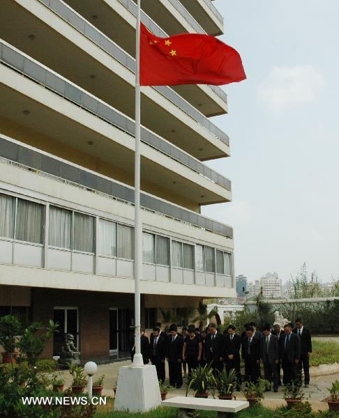 The Chinese flag flies at half mast as staff members of the Chinese Embassy pay a silent tribute to the victims of the Aug. 8 mudslide disaster in Zhouqu County, Gannan Tibetan Autonomous Prefecture in northwest China's Gansu Province, in Beirut, capital of Lebanon, Aug. 15, 2010. 