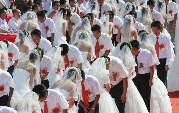 Couples hold a group wedding ceremony in Lushan County, central China's Henan Province, Aug 16, 2010.