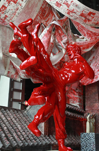 A red ceramic statue depicts an eight-legged Bruce Lee, known as Li Xiaolong in Chinese, at Foshan case pavilion inside Expo Park, Aug 17, 2010. 