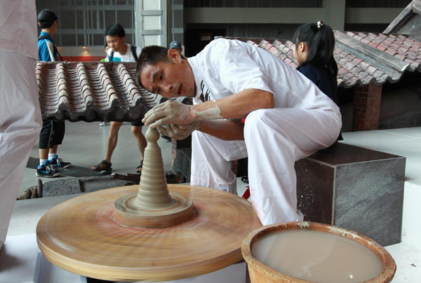 A craftsman demonstrates his pottery making skills at Foshan case pavilion inside Shanghai Expo Park, Aug 17, 2010.