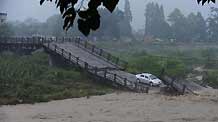 Photo taken on Aug. 19, 2010 shows a collapsed bridge triggered by heavy rain in Huaiyuan Township in Chengdu City, capital of southwest China's Sichuan Province, Aug. 19, 2010.