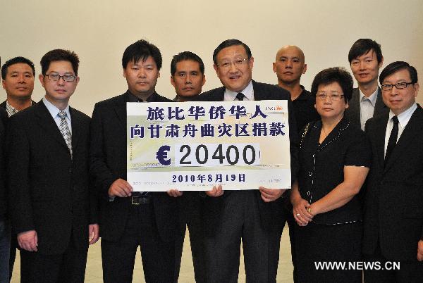 Chinese Ambassador to Belgium Zhang Yuanyuan (5th R) stands with representatives of overseas Chinese in Belgium during a charity donation for mudslide-hit Zhouqu County of northwest China's Gansu Province, in Brussels, capital of Belgium, Aug. 19, 2010.