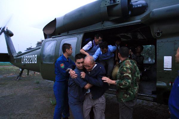 Soldiers evacuate villagers surrounded by flood to a safe place in Pujiang County, Chengdu City, capital of southwest China's Sichuan Province, Aug. 19, 2010.