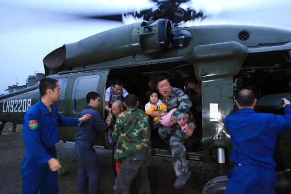 Soldiers evacuate villagers surrounded by flood to a safe place in Pujiang County, Chengdu City, capital of southwest China's Sichuan Province, Aug. 19, 2010.