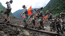 Rescuers walk in mudslides-hit Puladi Township of Gongshan Drung-Nu Autonomous County, southwest China's Yunnan Province, Aug. 19, 2010.