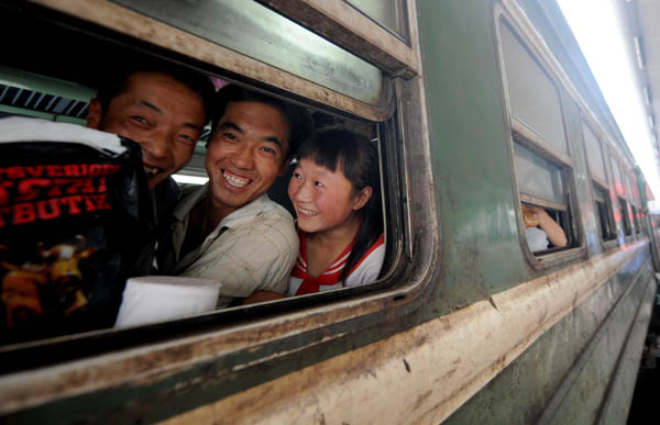 Farmers board a train bound for Xinjiang Uygur Autonomous Region at a railway station in Tianshui, northwest China's Gansu Province, Aug 20, 2010. 