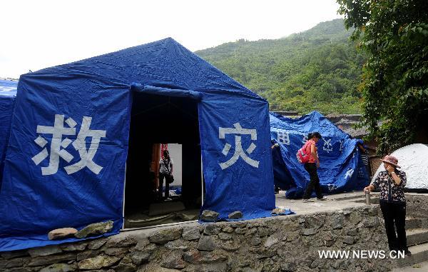 People get rest at a temporary shelter in the mudslide-hit Puladi Township of Gongshan Drung-Nu Autonomous County, southwest China&apos;s Yunnan Province, Aug. 20, 2010. 