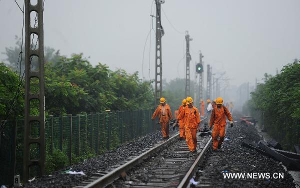 Workers restore tracks of the Baoji-Chengdu Railway in Xiaohan Township of Guanghan, a city of Sichuan Province, Aug. 20, 2010. 