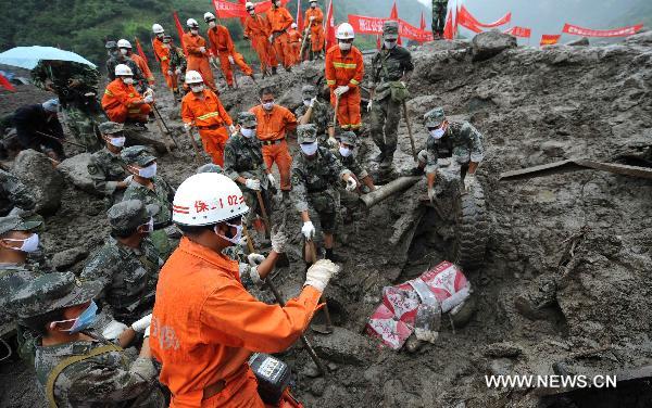 Rescuers find a victim&apos;s body which is covered by hardboard in mudslide-hit Puladi Township of Gongshan Drung-Nu Autonomous County, southwest China&apos;s Yunnan Province, Aug. 20, 2010.