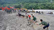 Rescuers clear off sludge in mudslide-hit Puladi Township of Gongshan Drung-Nu Autonomous County, southwest China's Yunnan Province, Aug. 20, 2010.