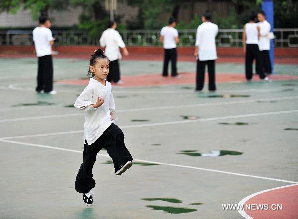 Members of the kungfu team under the Wudang Taoist Association perform Wudang Taiji kungfu at the World Expo Park, in Shanghai, east China, Aug. 18, 2010. 