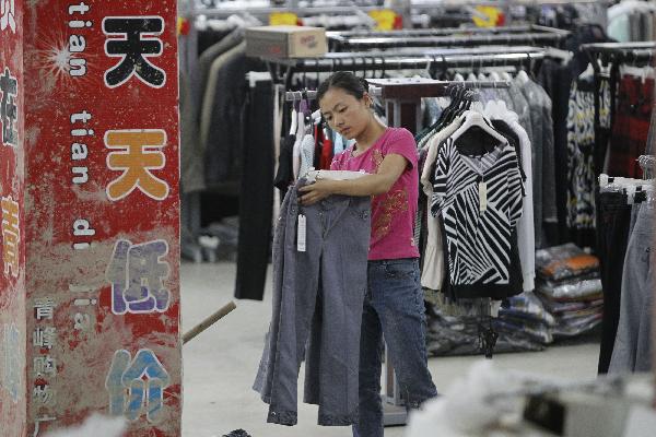 A woman shops at a resumed shopping center in the landslide-hit Zhouqu County, Gannan Tibetan Autonomous Prefecture in northwest China's Gansu Province, Aug. 20, 2010.