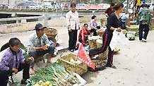 Residents sell vegetables on a street in the landslide-hit Zhouqu County, Gannan Tibetan Autonomous Prefecture in northwest China's Gansu Province, Aug. 20, 2010.